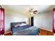 Bedroom featuring hardwood floors, ceiling fan, and double door closet at 1515 W Lake Cannon Nw Dr, Winter Haven, FL 33881