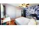 Stylish bedroom featuring wood floors, closet, ceiling fan and geometric accent wall with bright natural lighting at 1515 W Lake Cannon Nw Dr, Winter Haven, FL 33881