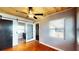 Bedroom features hardwood floors, a ceiling fan, and a sliding barn door with access to an enclosed porch at 1515 W Lake Cannon Nw Dr, Winter Haven, FL 33881