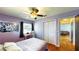 This bedroom has hardwood floors, closet, ceiling fan and geometric accent wall with bright natural lighting at 1515 W Lake Cannon Nw Dr, Winter Haven, FL 33881