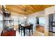 This dining area has a wooden ceiling, a view into the living area, and a stainless-steel refrigerator at 1515 W Lake Cannon Nw Dr, Winter Haven, FL 33881