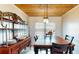 Bright dining room featuring wood table, decorative hutch, light fixture, and shiplap accent wall at 1515 W Lake Cannon Nw Dr, Winter Haven, FL 33881