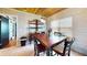 Bright dining room with a wood table, rustic hutch, and large window, offering a charming space for meals at 1515 W Lake Cannon Nw Dr, Winter Haven, FL 33881