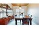 Bright dining room featuring wood table, decorative hutch, light fixture, and shiplap accent wall at 1515 W Lake Cannon Nw Dr, Winter Haven, FL 33881