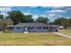 Quaint single-story home with a well-manicured lawn and established trees at 1515 W Lake Cannon Nw Dr, Winter Haven, FL 33881
