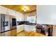 Kitchen showcases stainless steel appliances, dark granite countertops, white cabinets, and a wooden ceiling at 1515 W Lake Cannon Nw Dr, Winter Haven, FL 33881