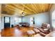 Inviting living room with hardwood floors, a wooden ceiling, a ceiling fan, and comfortable furniture at 1515 W Lake Cannon Nw Dr, Winter Haven, FL 33881