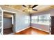 Living room features hardwood floors, tongue and groove ceiling and staircase to another level at 1515 W Lake Cannon Nw Dr, Winter Haven, FL 33881