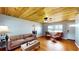 Spacious living room features beautiful hardwood floors, a wooden ceiling, a ceiling fan, and natural light at 1515 W Lake Cannon Nw Dr, Winter Haven, FL 33881