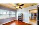 Bright living room with wood ceiling and hardwood floors, plus large window and a view into the kitchen at 1515 W Lake Cannon Nw Dr, Winter Haven, FL 33881