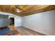 This cozy living room features a wood-paneled ceiling, barn door, and modern ceiling fan at 1515 W Lake Cannon Nw Dr, Winter Haven, FL 33881