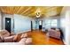 This living room features hardwood floors, a wooden ceiling, a ceiling fan, and stylish furnishings at 1515 W Lake Cannon Nw Dr, Winter Haven, FL 33881