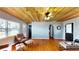 This living room offers hardwood floors, a wooden ceiling, a ceiling fan, and lots of space to relax at 1515 W Lake Cannon Nw Dr, Winter Haven, FL 33881