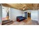 This bright living room features a futon and wood-paneled ceiling at 1515 W Lake Cannon Nw Dr, Winter Haven, FL 33881