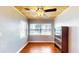 Sunlit living room boasts hardwood floors, wood ceiling, and a large window showcasing the exterior at 1515 W Lake Cannon Nw Dr, Winter Haven, FL 33881