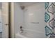 A clean bathtub with shower features bright white tile and convenient grab bar at 1700 6Th Nw St # C26, Winter Haven, FL 33881