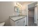 Bright bathroom features a modern vanity with granite countertop and stylish mirror at 1700 6Th Nw St # C26, Winter Haven, FL 33881