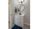Modern bathroom with a sleek vanity, round mirror, and contemporary fixtures at 1700 6Th Nw St # C26, Winter Haven, FL 33881