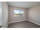 A sun filled room with gray floors and a bright window at 1700 6Th Nw St # C26, Winter Haven, FL 33881