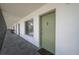 Inviting front door entrance with a welcoming mat on an open air corridor at 1700 6Th Nw St # C26, Winter Haven, FL 33881