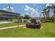 Outdoor brick grill and picnic area set in a lush, green space with community pool nearby at 1700 6Th Nw St # C26, Winter Haven, FL 33881