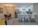 Bright kitchen featuring white cabinetry, stainless steel appliances, a breakfast bar and an adjacent dining area at 1700 6Th Nw St # C26, Winter Haven, FL 33881