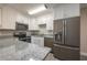 Well-lit kitchen offers stainless steel appliances, granite countertops, and ample cabinet space at 1700 6Th Nw St # C26, Winter Haven, FL 33881