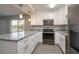 Beautiful kitchen featuring granite countertops, modern stainless steel appliances, and white cabinetry at 1700 6Th Nw St # C26, Winter Haven, FL 33881