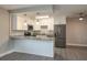 A cozy kitchen equipped with stone countertops, white cabinets, stainless steel appliances and modern lighting at 1700 6Th Nw St # C26, Winter Haven, FL 33881