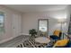 Charming living room with a modern rug, stylish furniture, and a large mirror reflecting the kitchen at 1700 6Th Nw St # C26, Winter Haven, FL 33881