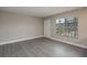 Bright and spacious living room boasting stylish gray flooring and natural light from the large window at 1700 6Th Nw St # C26, Winter Haven, FL 33881