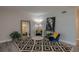 Cozy living room features a stylish rug, comfortable seating, decorative artwork, and a large mirror at 1700 6Th Nw St # C26, Winter Haven, FL 33881