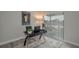 Bright office space featuring modern black desk, rolling chairs, and a window view; perfect for working from home at 1700 6Th Nw St # C26, Winter Haven, FL 33881
