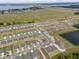 Overhead perspective highlighting a planned community close to a lake and open fields, with new homes nestled within cul-de-sacs at 1752 Forest Run Ln, Auburndale, FL 33823