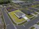 Aerial view showcasing the home's neat landscaping, clean white driveway, and proximity to a serene lake at 1752 Forest Run Ln, Auburndale, FL 33823