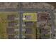 Bird's-eye view of a cozy home nestled in a residential neighborhood with neatly arranged homes and a nearby construction site at 1752 Forest Run Ln, Auburndale, FL 33823