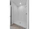 Modern bathroom showcasing a pristine, all-white tiled walk-in shower with a sleek shower head at 1752 Forest Run Ln, Auburndale, FL 33823