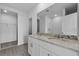 Bright bathroom featuring double vanity with granite countertop, undermount sinks, and spacious walk-in closet at 1752 Forest Run Ln, Auburndale, FL 33823