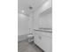 Bright bathroom with white cabinets, granite countertop, tiled shower, and wood-look tile flooring at 1752 Forest Run Ln, Auburndale, FL 33823