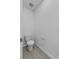 Powder room with a toilet and wood-look tile flooring at 1752 Forest Run Ln, Auburndale, FL 33823