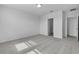Bright, carpeted bedroom with a large window and doorways to other areas of the house at 1752 Forest Run Ln, Auburndale, FL 33823