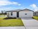 Charming single-story home with a well-manicured lawn and inviting front entrance at 1752 Forest Run Ln, Auburndale, FL 33823