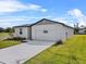 Well-maintained one-story home with a two-car garage and lush green lawn at 1752 Forest Run Ln, Auburndale, FL 33823