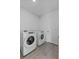Well-lit laundry area with modern washer and dryer set and wood-look tile flooring at 1752 Forest Run Ln, Auburndale, FL 33823