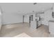 Open-concept living area, showcasing stylish flooring, a kitchen island, and stainless-steel appliances at 1752 Forest Run Ln, Auburndale, FL 33823