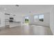 Open-concept living space with tile floors and a modern kitchen with stainless appliances at 1752 Forest Run Ln, Auburndale, FL 33823