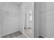 Spacious walk-in closet with shelving and doorway to an en-suite bathroom at 1752 Forest Run Ln, Auburndale, FL 33823
