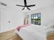 Bright bedroom featuring a ceiling fan, stylish mirror, and natural light from a large window at 1850 S Lake Reedy Blvd, Frostproof, FL 33843
