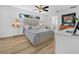 Light-filled bedroom featuring wood flooring, a ceiling fan, and an ensuite bathroom at 1850 S Lake Reedy Blvd, Frostproof, FL 33843