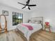 Cozy bedroom with wood flooring, ceiling fan, and view of the golf course at 1850 S Lake Reedy Blvd, Frostproof, FL 33843